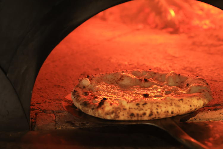 特製の薪窯で焼き上げる本格ピザ